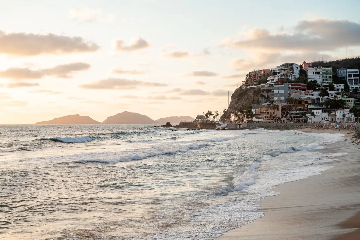 Spectacular Pacific sunset with waves crashing at the Olas Altas malecon in Mazatlán